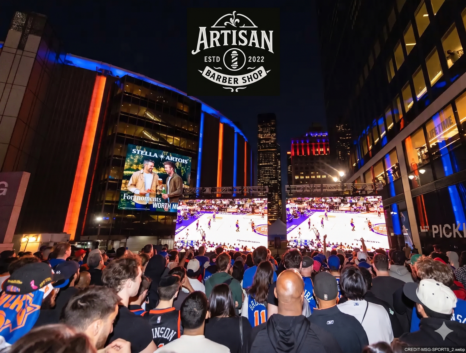 Exterior night view of Madison Square Garden with blue and orange lighting, a large crowd from behind.